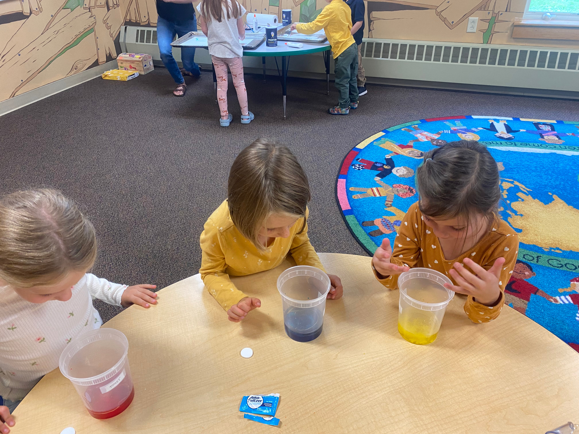 Children exploring a color-mixing science experiment