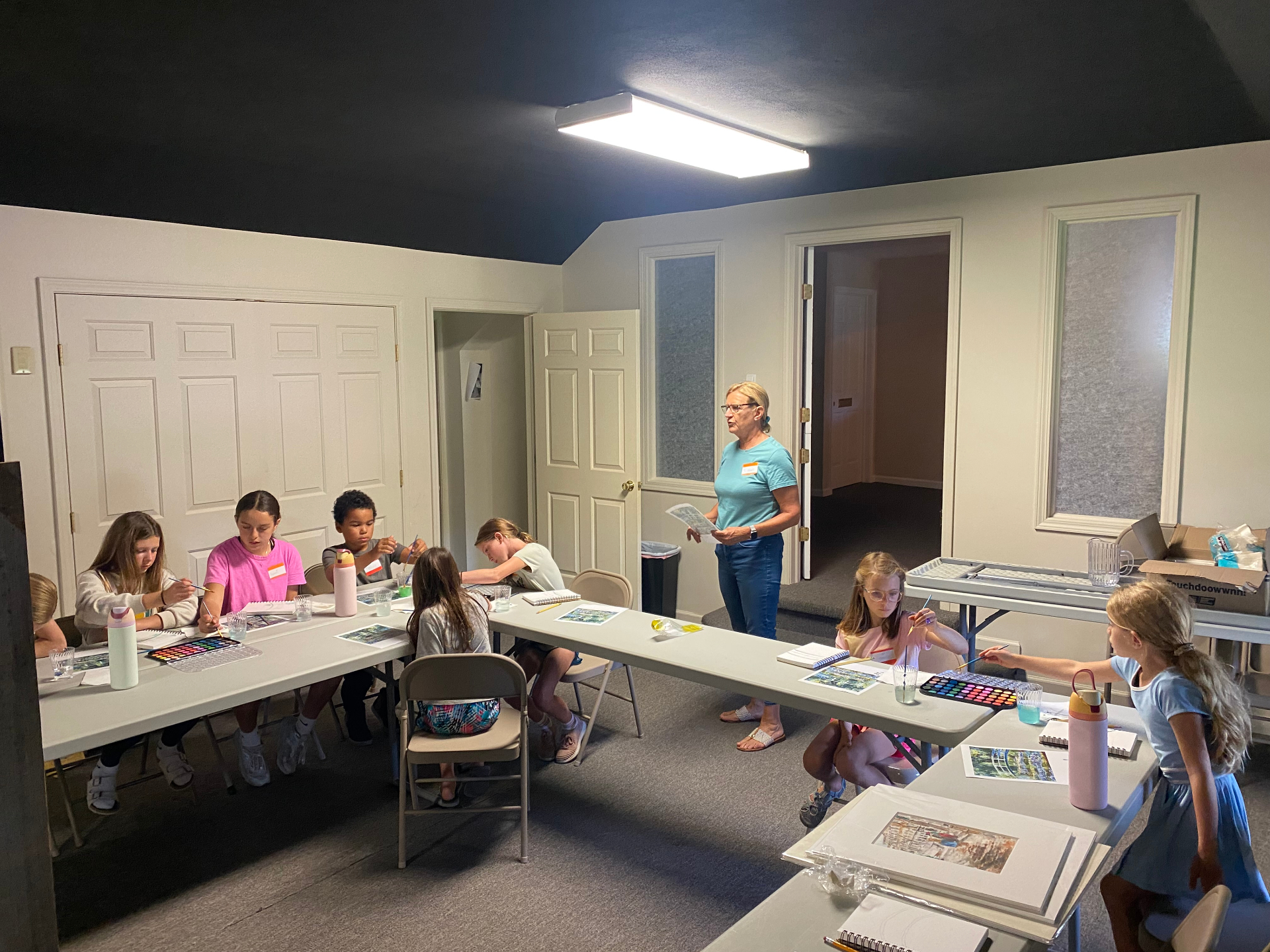 Students painting with watercolors in an art class